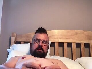 I'm playing with my nipples and hard cock and jerking off in my bed.